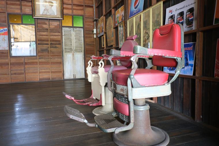 Vintage red barber chairs in a wooden shop
